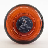 Bottom view of the amber glass vessel soy candle. Fragrance warm pumpkin spice.