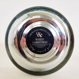 Bottom view of the chrome vessel candle. Fragrance White Christmas.