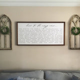 Two medium cathedral wall arches with small boxwood wreaths on either side of a large farmhouse sign. 